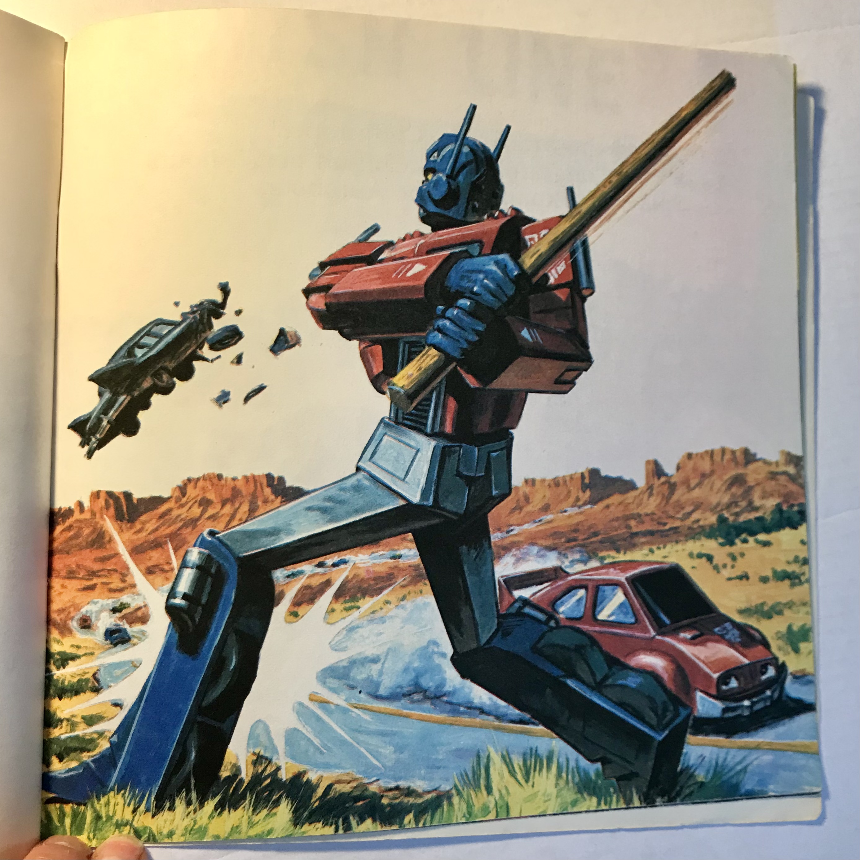 Optimus Prime hits Megatron with a telegraph pole